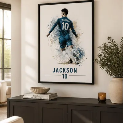 Framed personalised footballer print above a charcoal sideboard