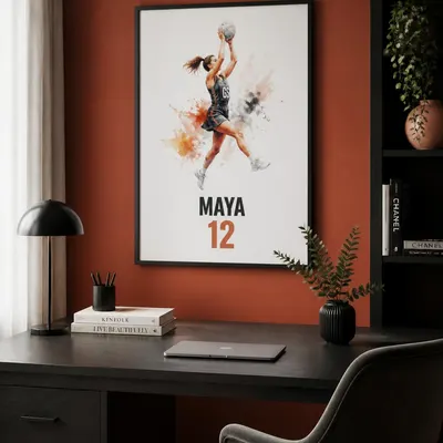 Framed personalised netball print on a burnt orange wall above a desk